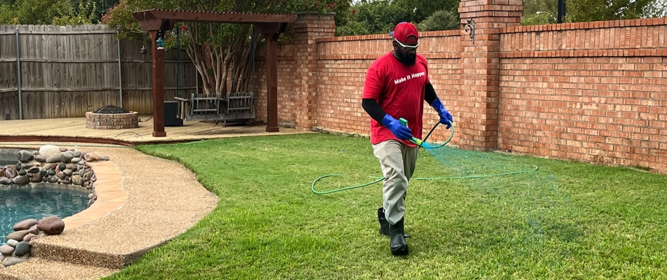 Professional applying fertilizer to lawn after TARR control treatment in Lakeside, TX.